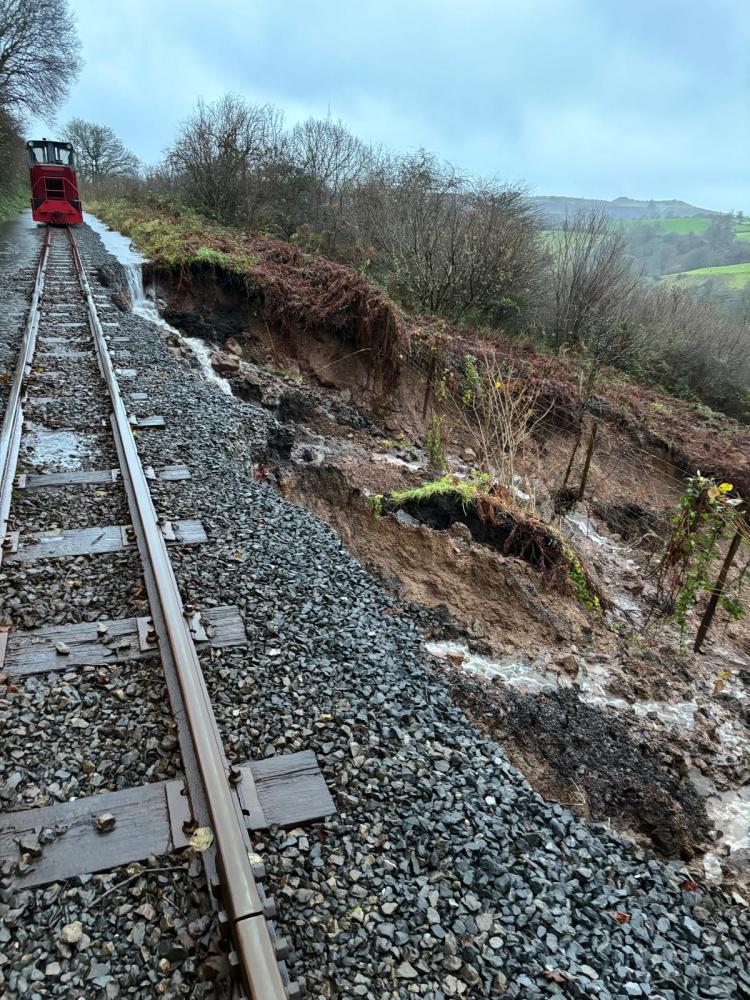 a train traveling down a dirt road